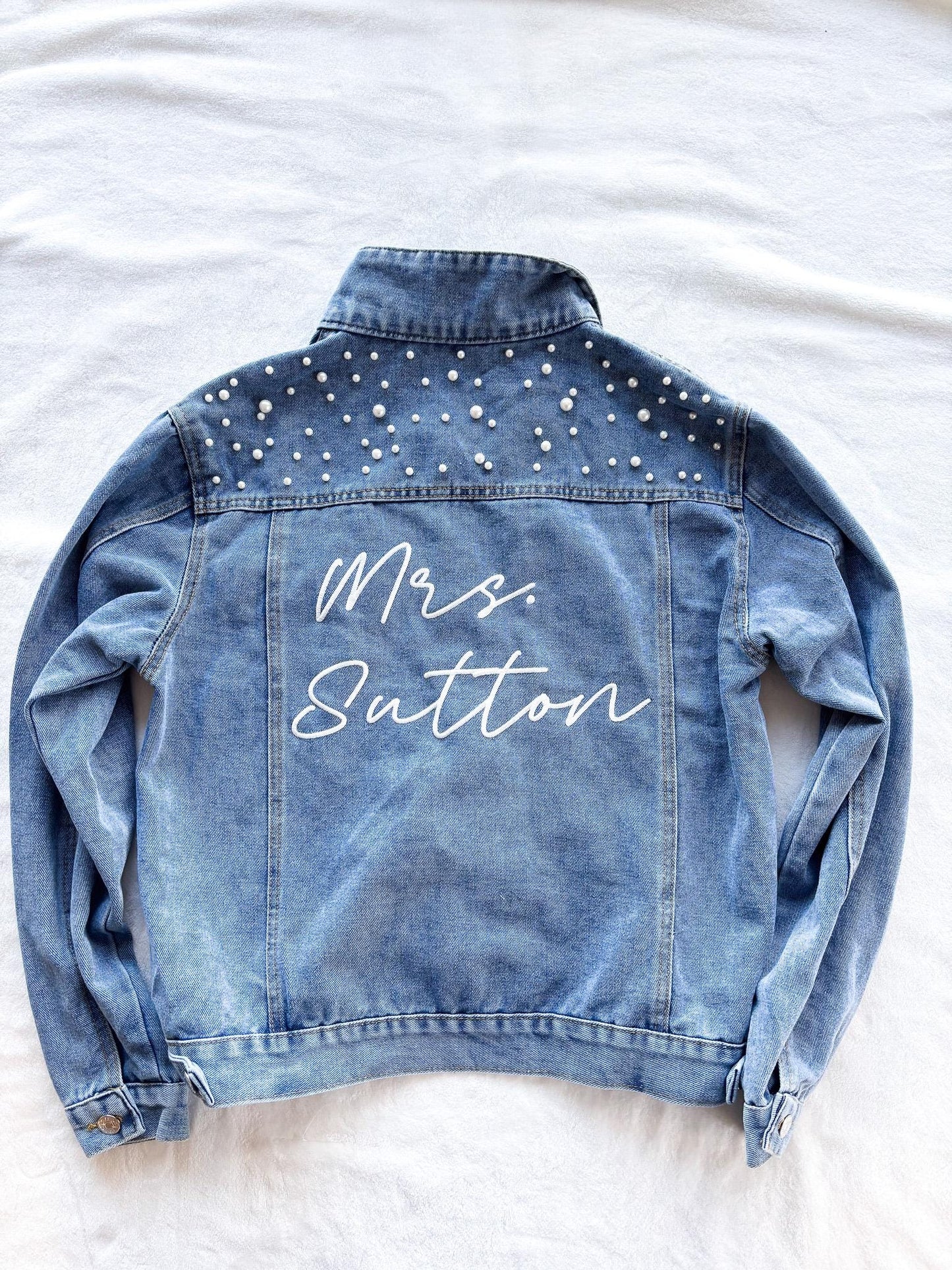 a jean jacket that says mr and mrs baton on it