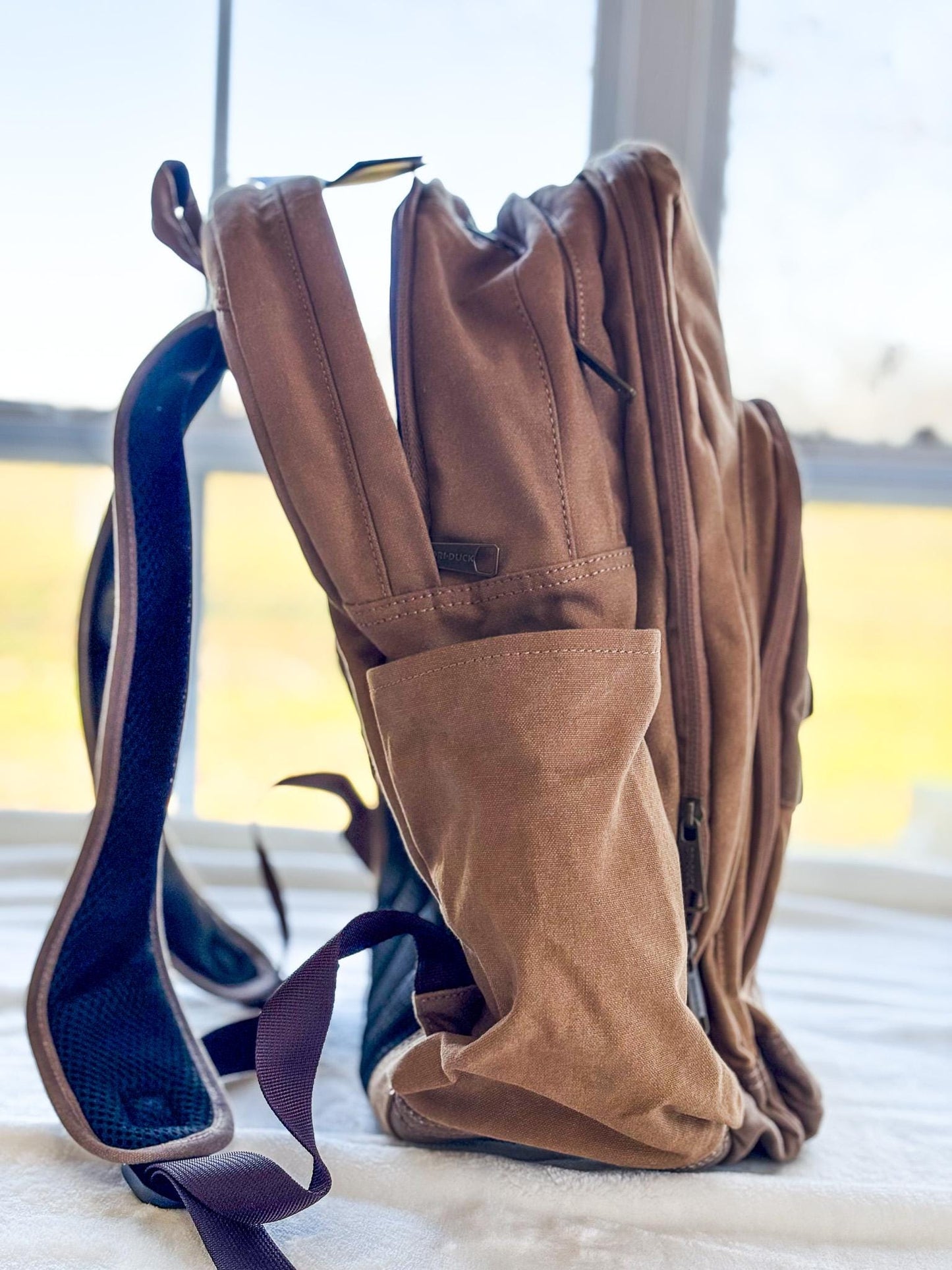 a pair of boots and a backpack sitting on a bed