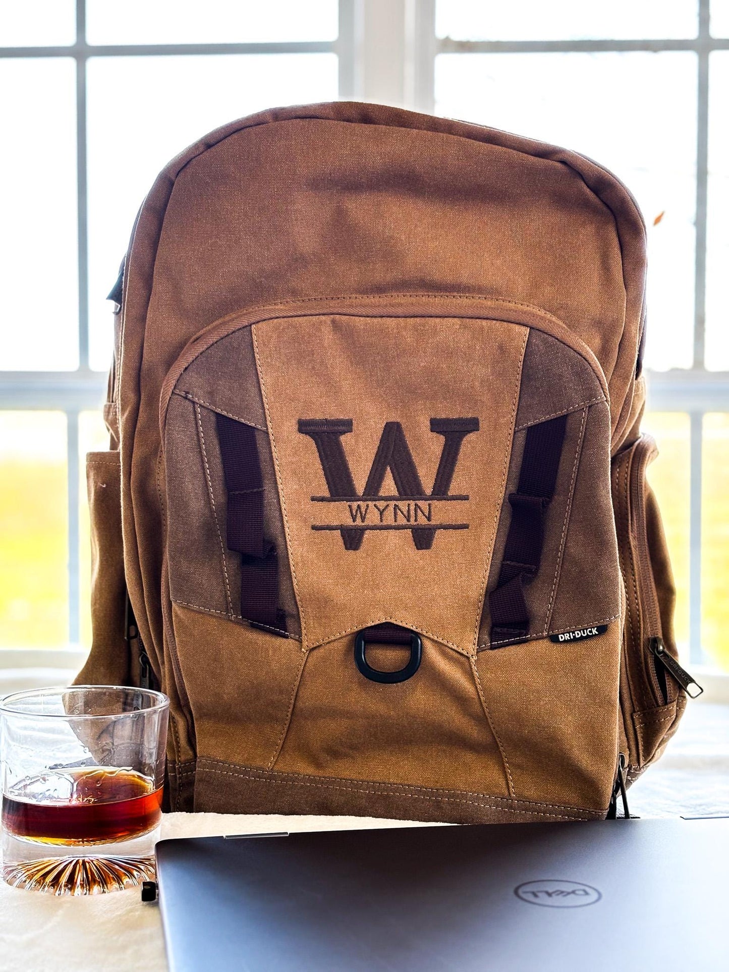 a brown backpack sitting on top of a table