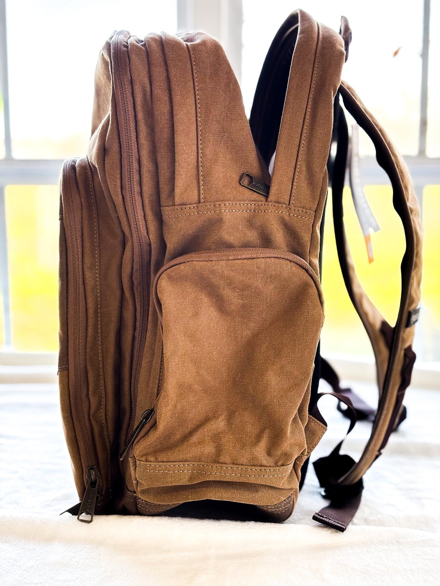 a backpack sitting on the floor in front of a window