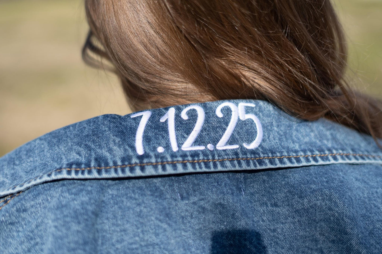 the back of a woman's jean jacket with the number 1235 on it