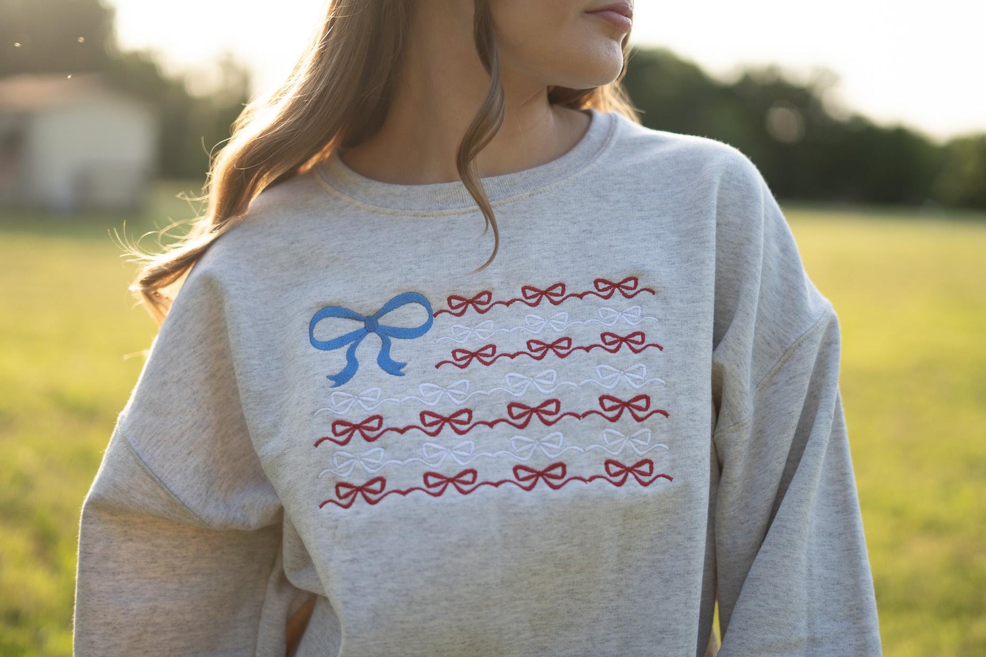 a woman wearing a sweatshirt with a bow on it