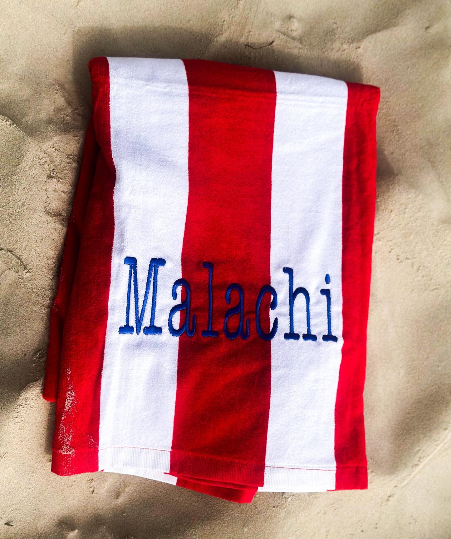 a red and white towel with a name on it