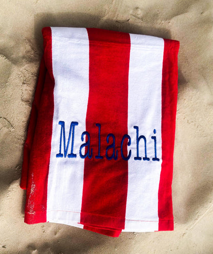 a red and white towel with a name on it