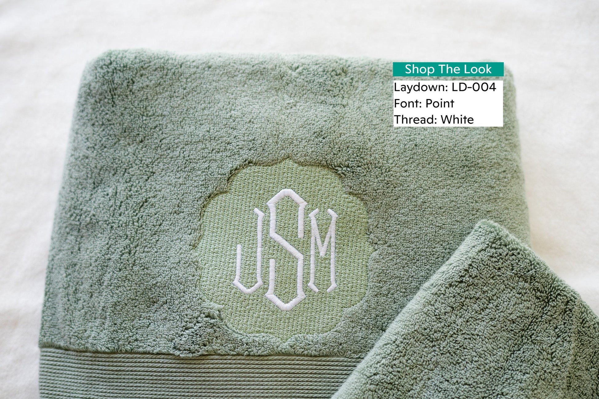 a close up of a towel with a monogram on it
