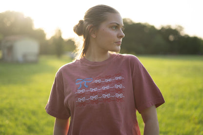 a woman standing in a field of green grass